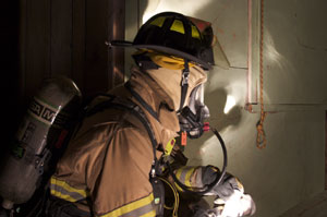 firefighter advancing hose